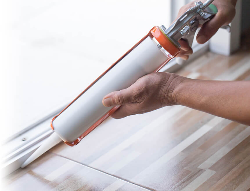 Window installer applying silicon calking