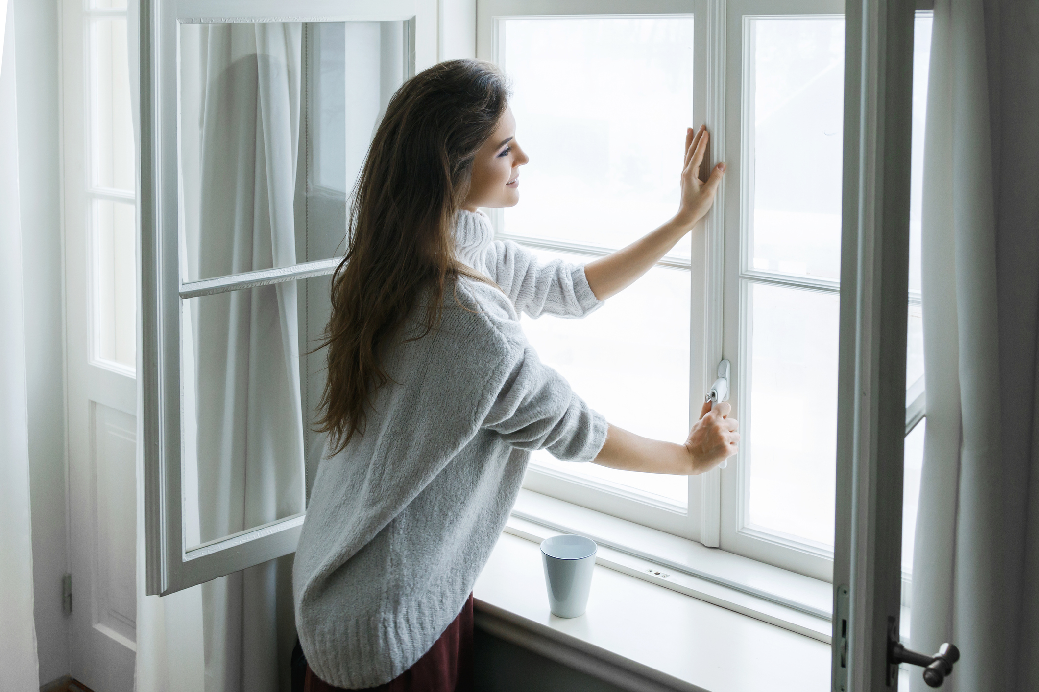 woman happy with window replacement costs